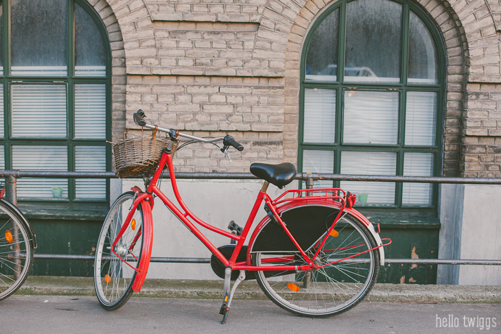 Red Bike parked against brownstone in Copenhagen