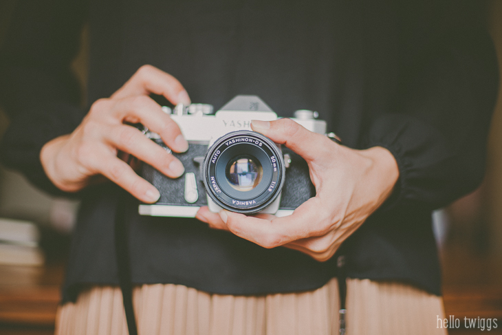 Woman holding a Yashica TL Electro X with her hands